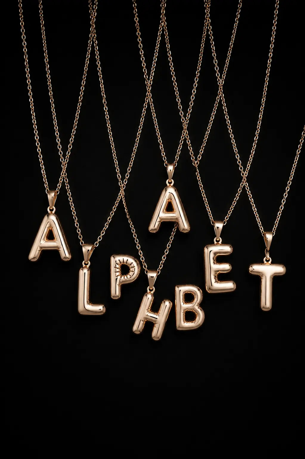Gold alphabet necklaces spelling 'ALPHABET' on a black background