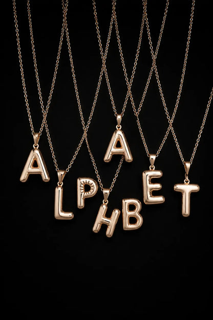 Gold alphabet necklaces spelling 'ALPHABET' on a black background