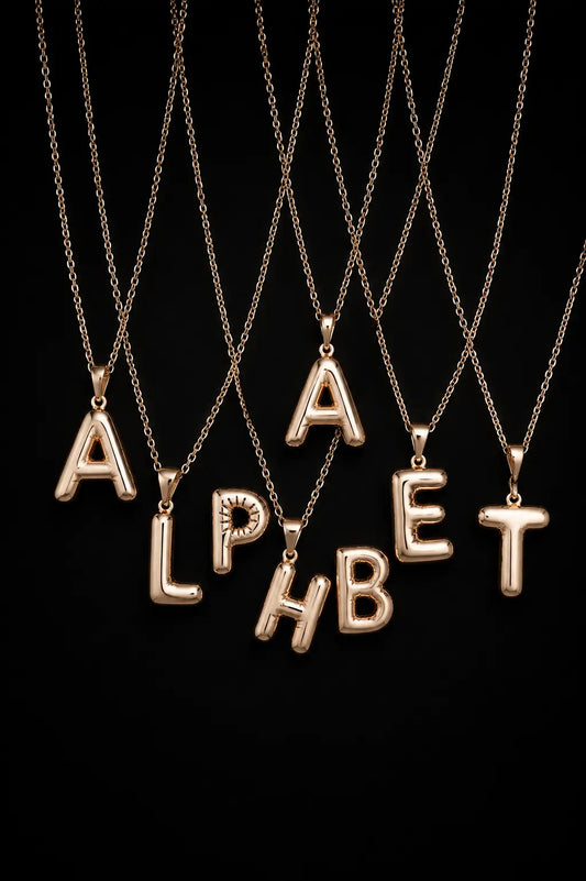 Gold alphabet necklaces spelling 'ALPHABET' on a black background