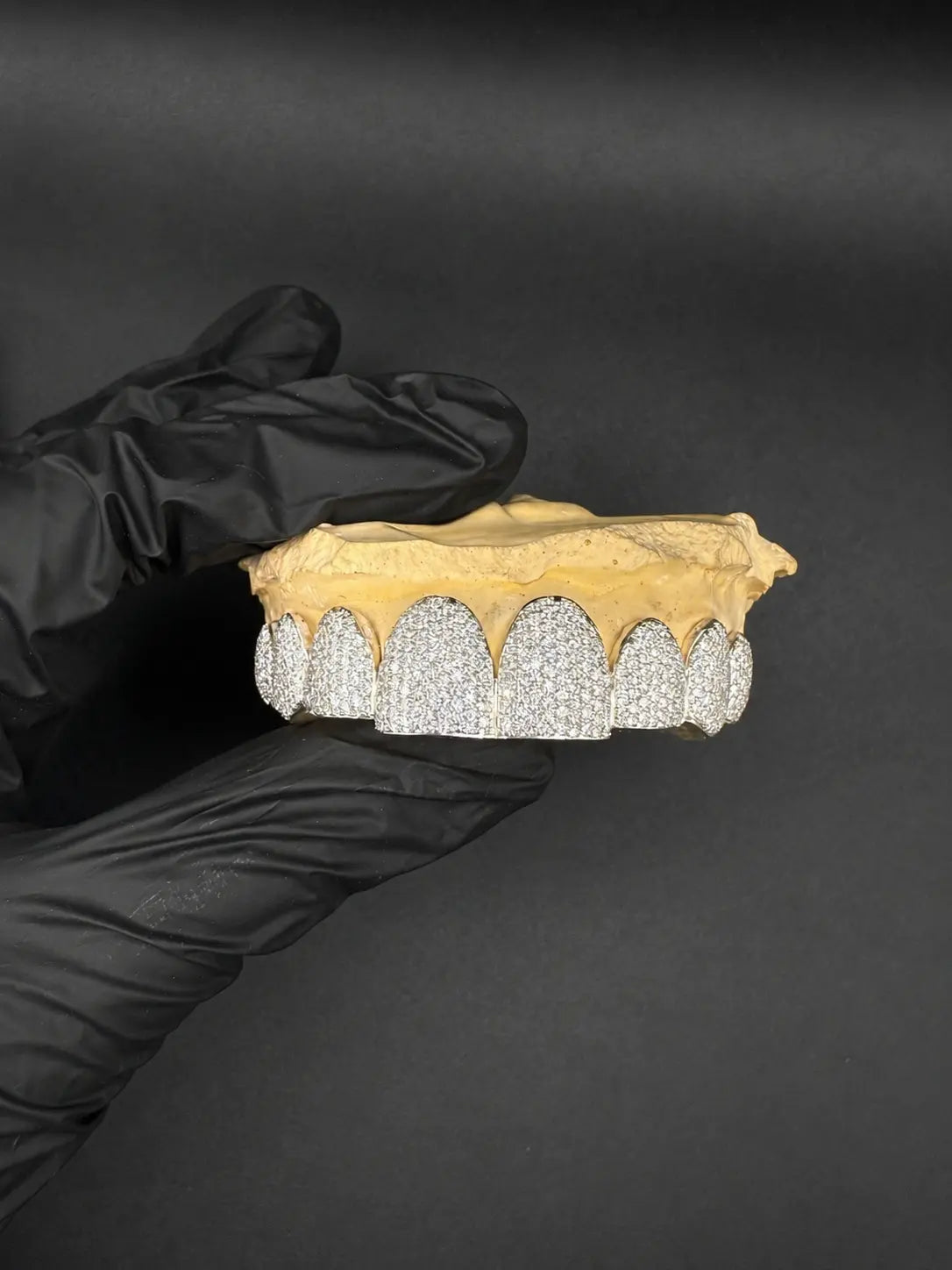 Close-up detail of hand-set VVS-Moissanite on bustdown grillz