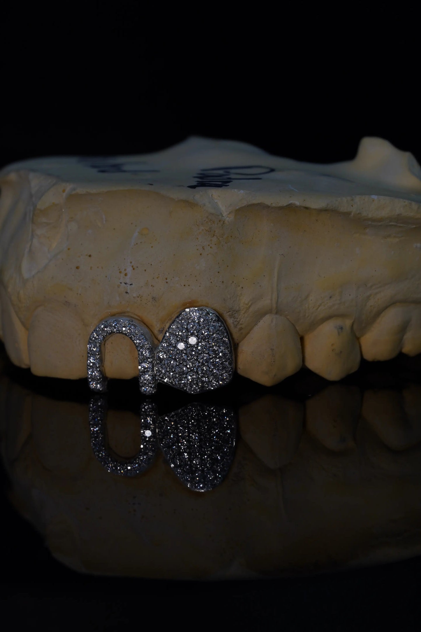 Custom two-tooth VVS lab diamond grillz with a Bustdown Cap and Parallel Window Cap in solid precious metal.