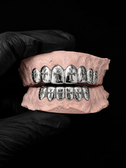 Custom CAD-designed cross grillz in sterling silver displayed on a dental mold with black luxury background