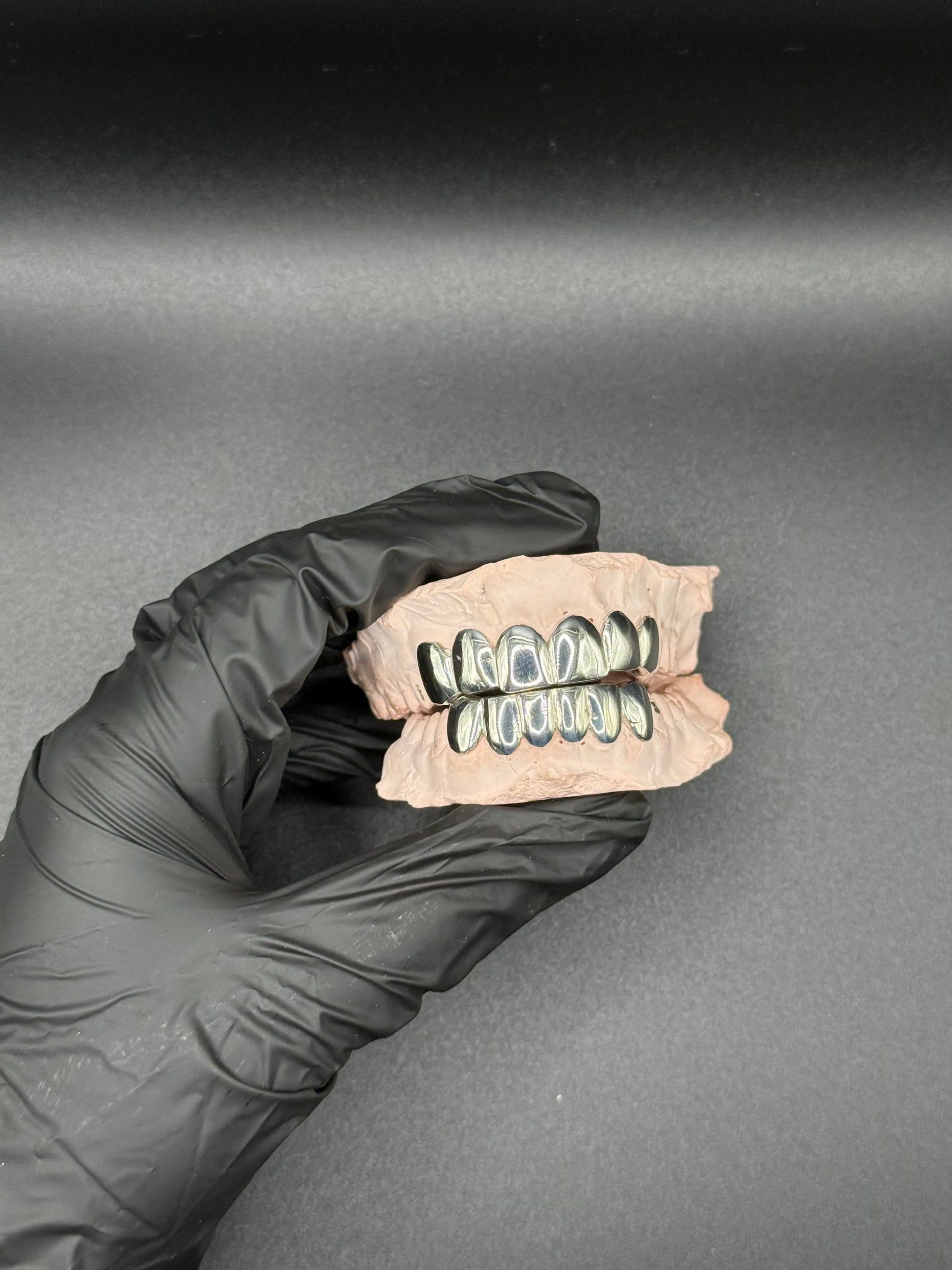 Angled view of custom handmade grillz in gold or silver