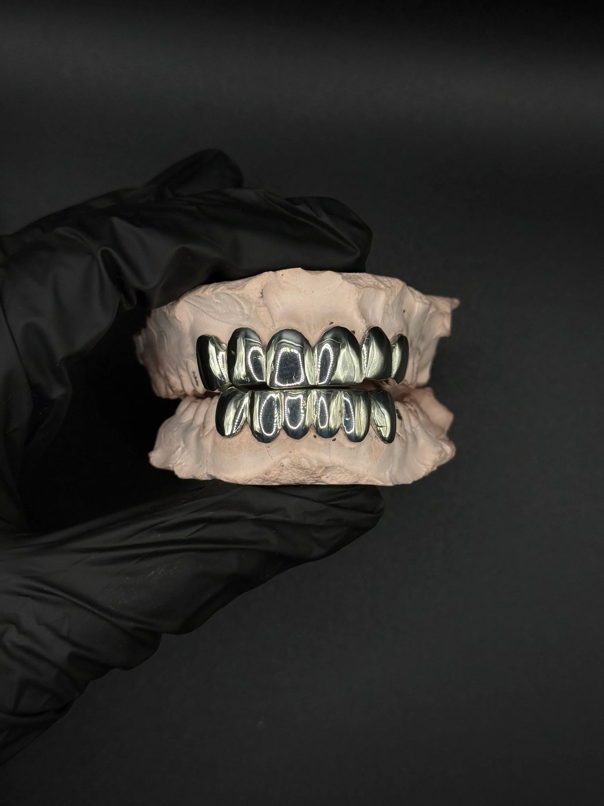 Custom handmade grillz in solid silver or gold with precision fit luxury dental jewelry