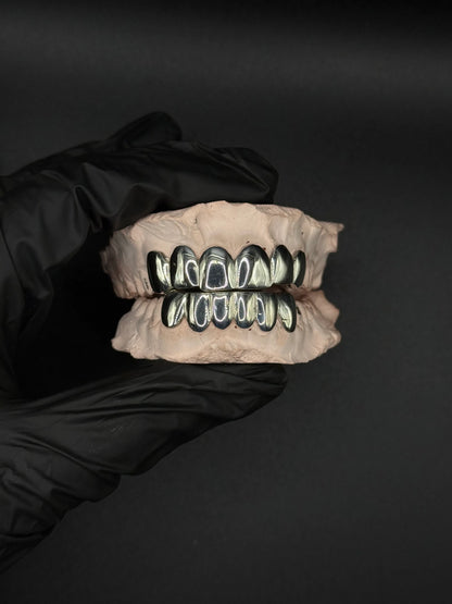 Custom handmade grillz in solid silver or gold with precision fit luxury dental jewelry