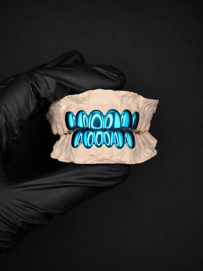 Glowing blue grill on a black background held by a black-gloved hand.