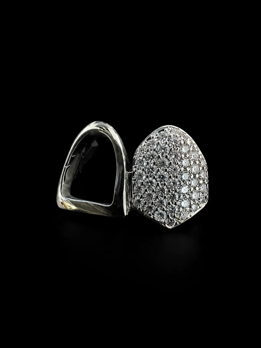 Close up of iced out VVS lab diamond grillz with pavé detailing and polished finish