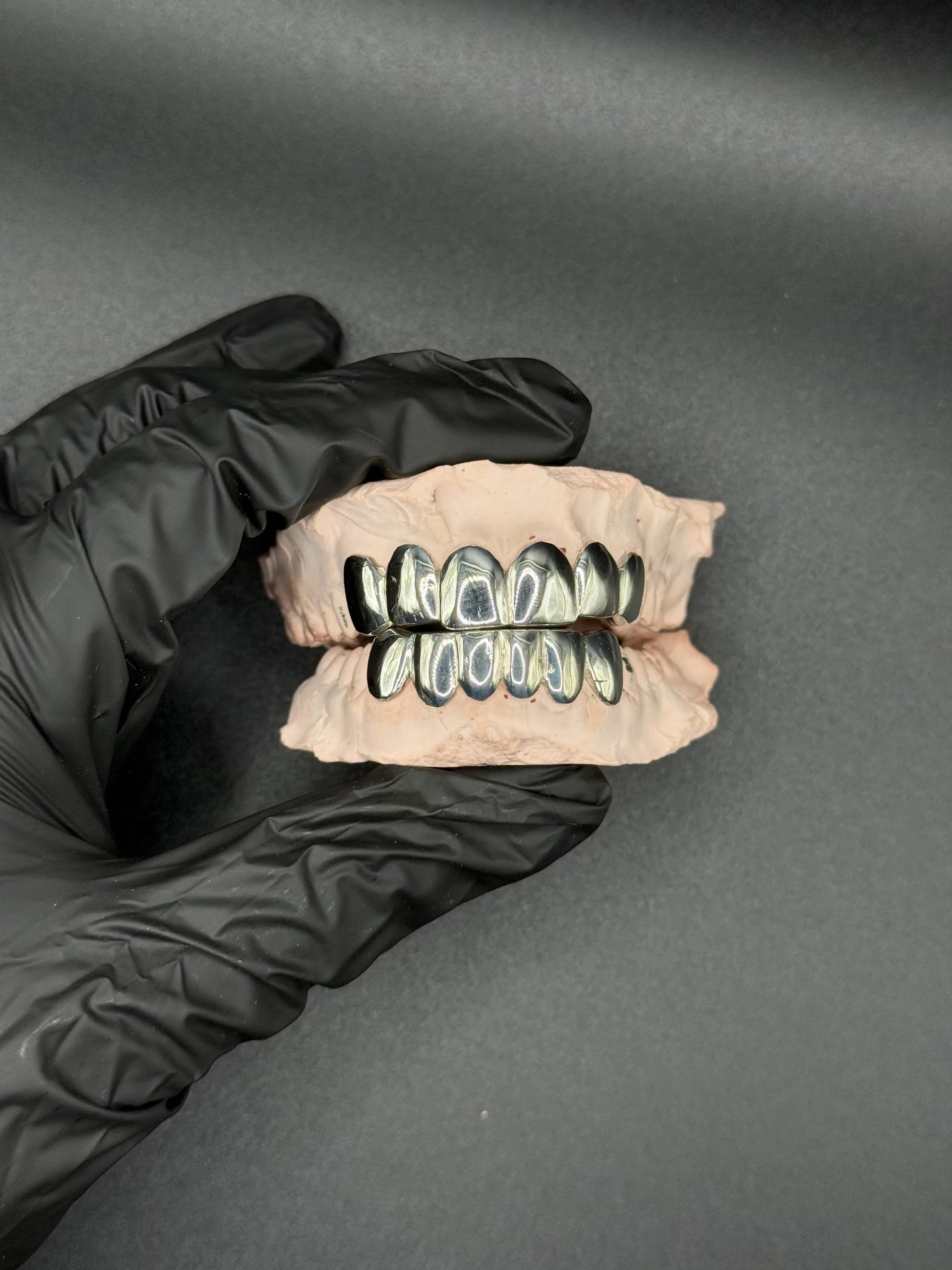 Extreme close-up of handmade luxury grillz showing detailed craftsmanship