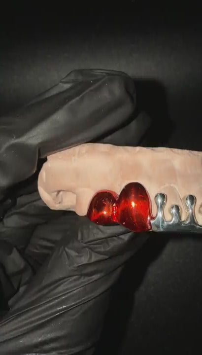 360 degree view of custom handmade sterling silver dripped grillz with red plated accents