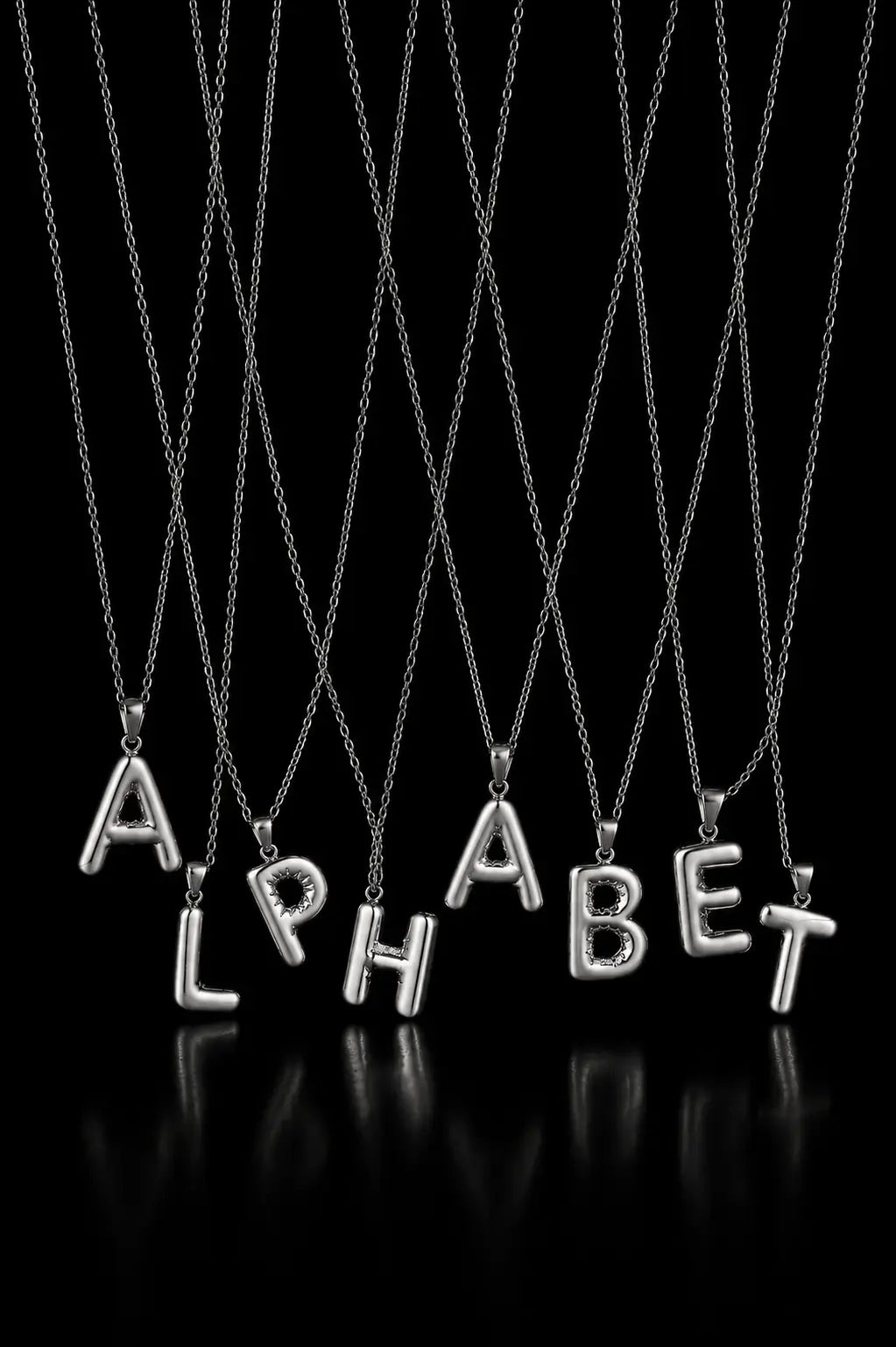 Silver alphabet necklaces spelling 'ALPHABET' on a black background
