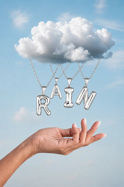 Silver 'RAIN' pendants hanging from a cloud against a blue sky.