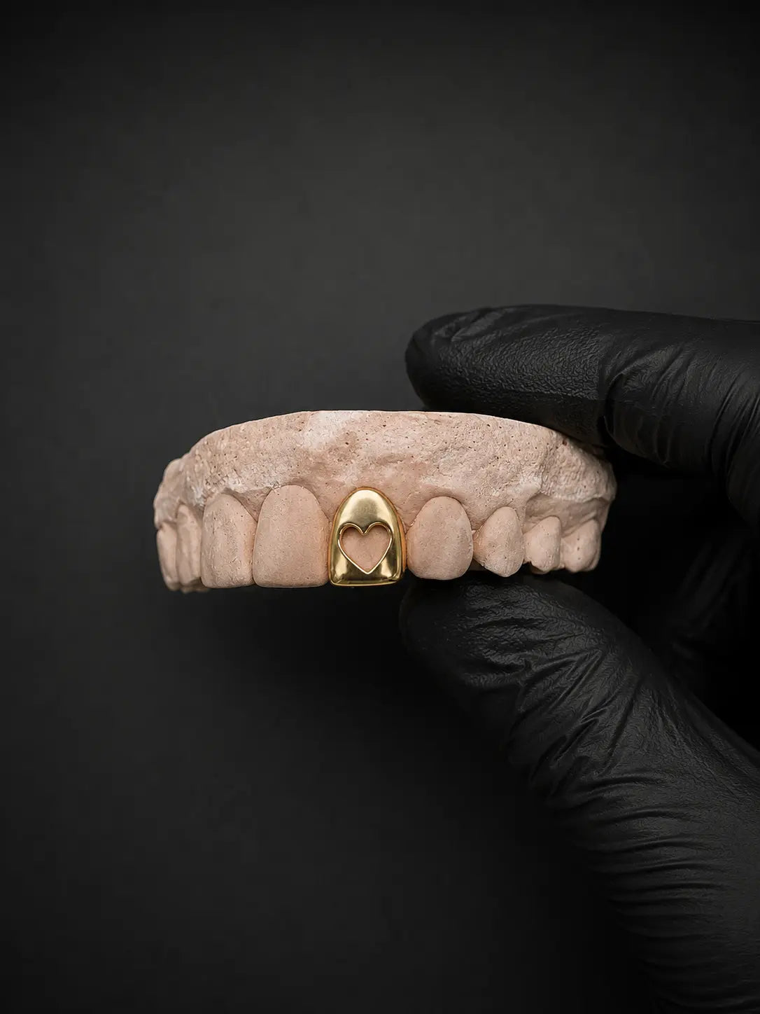 Silver hollow heart grillz custom dental jewelry close-up on tooth model
