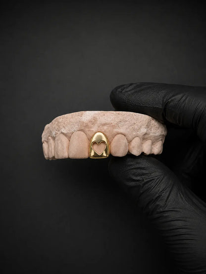 Silver hollow heart grillz custom dental jewelry close-up on tooth model