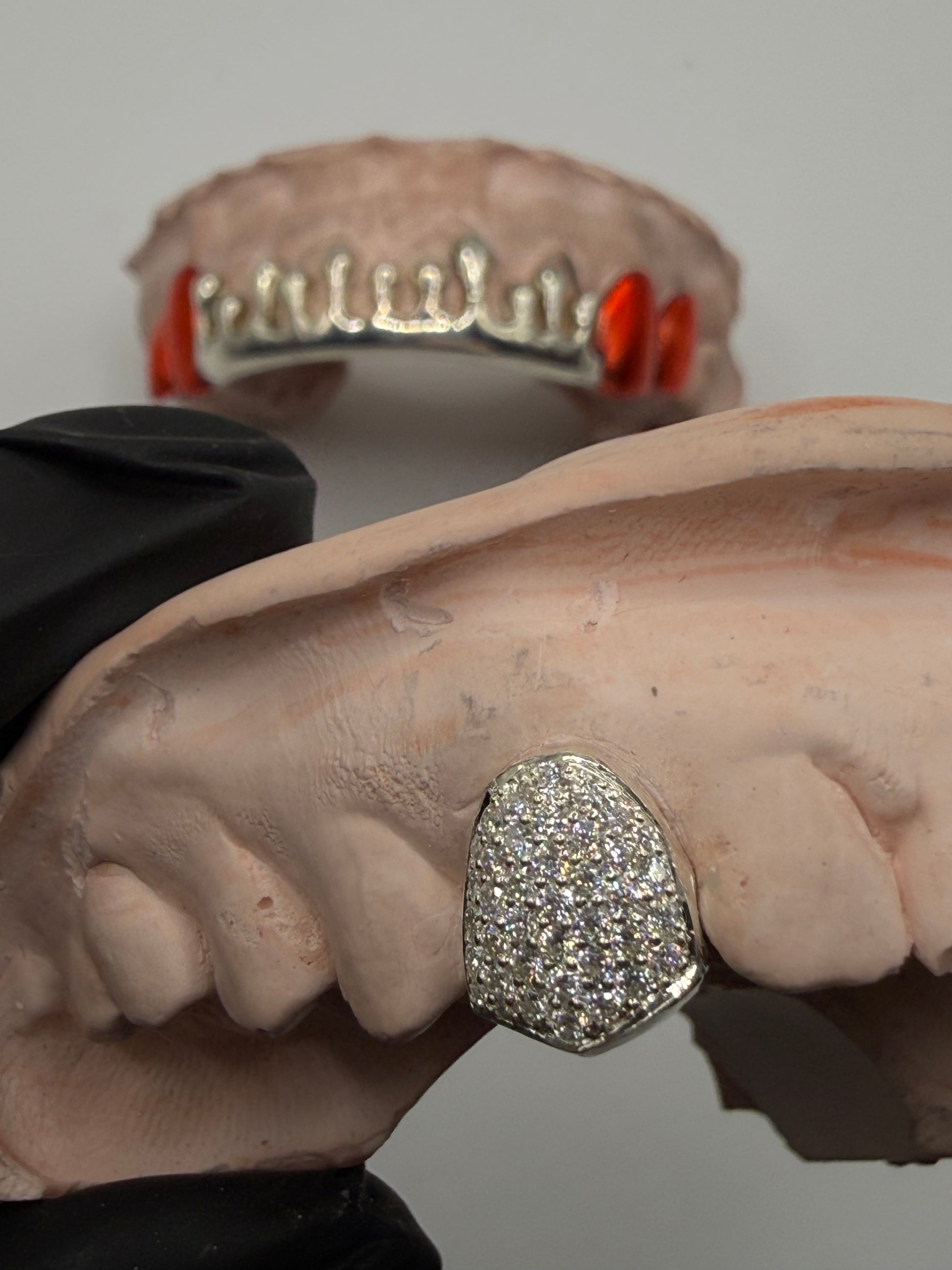 Close-up of single tooth moissanite grill showing iced out detail