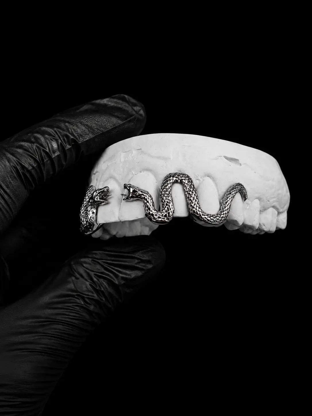 Close-up of custom snake grillz in silver with luxury serpent-inspired detailing